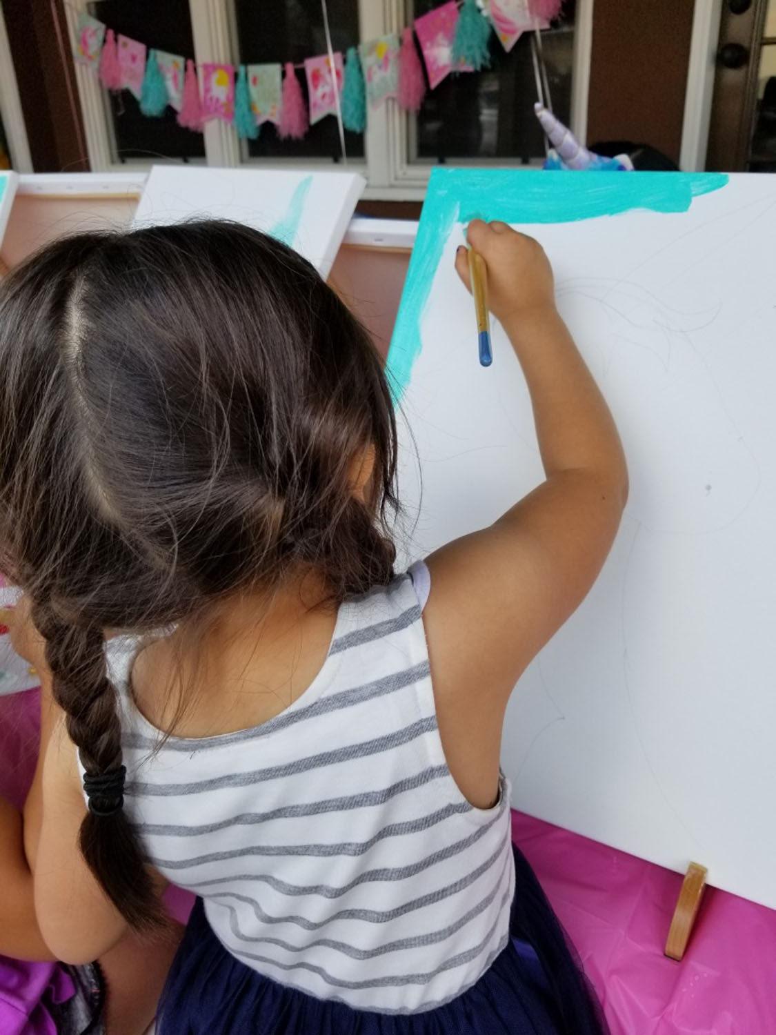 Young girl painting a picture.