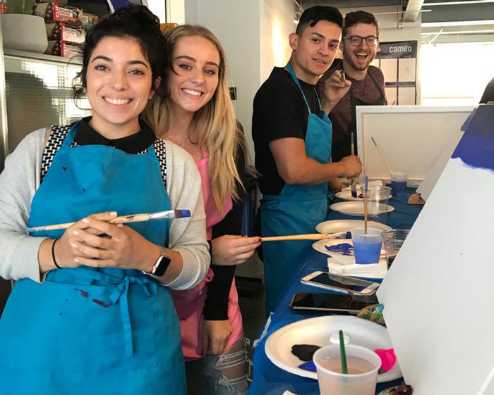 Group of adults at a painting event.